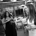 Bride laughing while groom and guest look on.