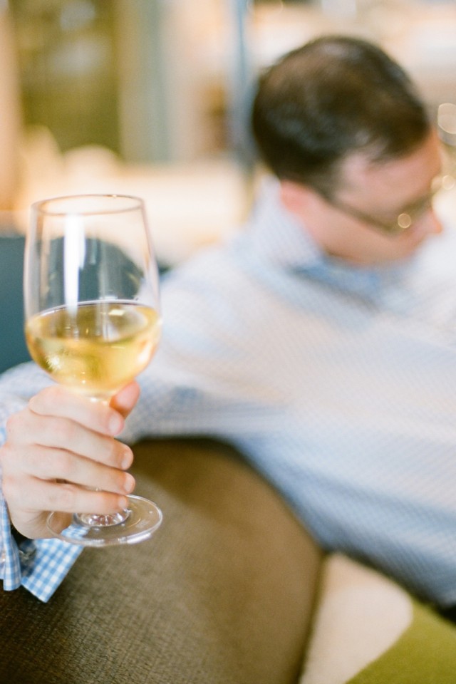 groom sipping white wine